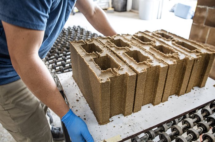 Prometheus Materials’ bio-cement is used to form zero-carbon Bio-Blocks on their way to finishing, evaporating and inventory. Source: Prometheus Materials.