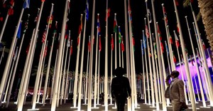 Image: Delegates stand near flag posts at the Dubai's Expo City after attending the World Climate Action Summit, during the United Nations Climate Change Conference (COP28) in Dubai, United Arab Emirates, 1 December 2023. Reuters/Thomas Mukoya./File Photo