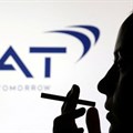 File photo: A woman poses with a cigarette in front of BAT (British American Tobacco) logo in this illustration taken 26 July 2022. Reuters/Dado Ruvic/Illustration/File Photo