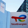 A logo of TotalEnergies is seen at an electric vehicle fuelling station in the La Defense business district in Courbevoie near Paris, France. Source: Reuters/Sarah Meyssonnier.