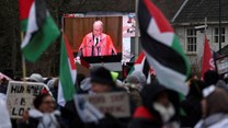 A view of a live broadcast displayed on a street as pro-Palestinian demonstrators protest near the International Court of Justice (ICJ) on the day judges hear a request for emergency measures to order Israel to stop its military actions in Gaza, in The Hague, Netherlands, 11 January 2024. Reuters/Thilo Schmuelgen