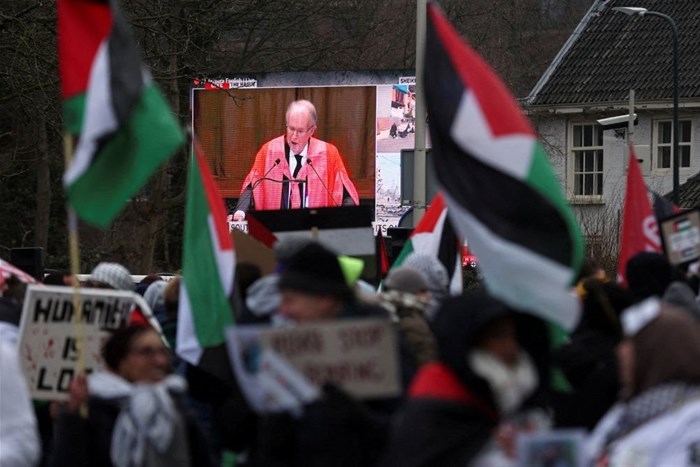 A view of a live broadcast displayed on a street as pro-Palestinian demonstrators protest near the International Court of Justice (ICJ) on the day judges hear a request for emergency measures to order Israel to stop its military actions in Gaza, in The Hague, Netherlands, 11 January 2024. Reuters/Thilo Schmuelgen