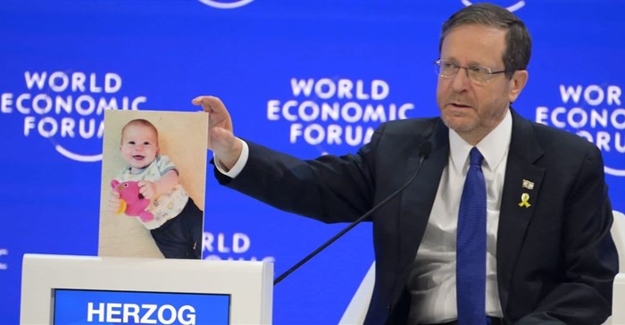 Source: Twitter/@Isaac_Herzog. Israeli President Isaac Herzog addressed The World Economic Forum's 54th Annual Meeting in Davos last week, calling on world leaders to not forget the hostages taken captive by Hamas gunmen on 7 October 2023. The hostages include both Israelis and Muslims, among them Kfir Bibas who turned one last week. President Herzog is seen here seated at #WEF2024 next to a photo of Kfir Bibas, taken shortly before Bibas was abducted.