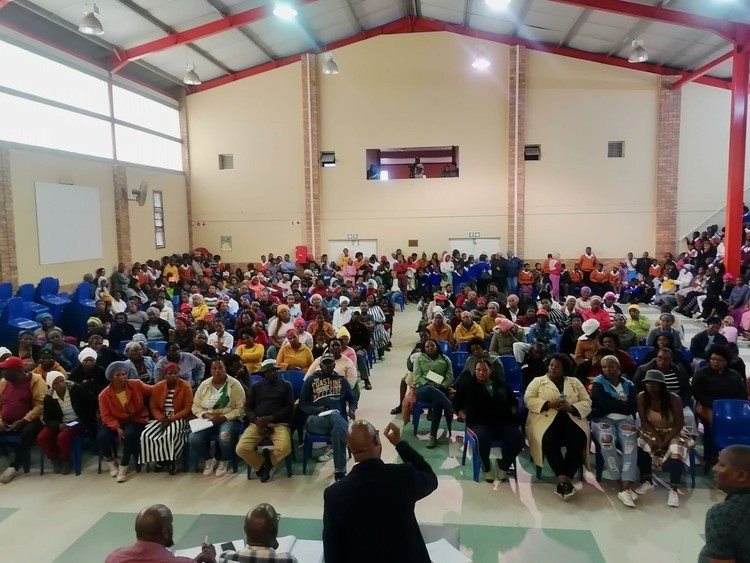 Hundreds of learners and parents attended a meeting on Monday in the Kyga Community Hall, Gqeberha, to get answers about why there is no scholar transport for 750 children in the township. Photo: Joseph Chirume.