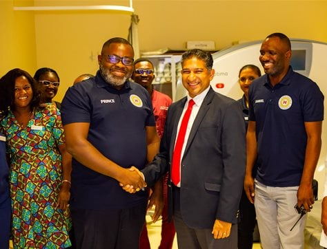 CEO Indren Poovan (on the right) congratulates Prince Rockson, head of the Radiology Unit and his team on reaching compliance with Cohsasa standards