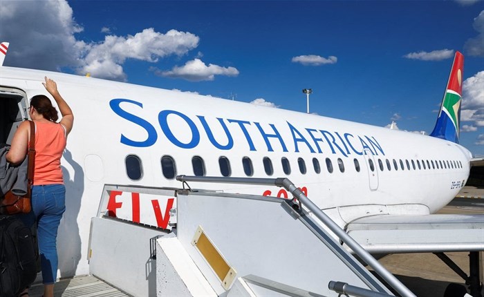 A passenger boards a South African Airways (SAA) plane at the Hosea Kutako International Airport, in Windhoek, Namibia, February 24, 2023. REUTERS/Siphiwe Sibeko
