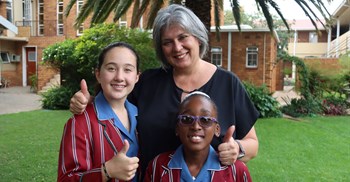 Source: Supplied. Holy Rosary pupils with principal Meerholz.