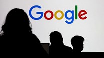 People stand in front of a Google logo during a media reception at the Google France headquarters ahead of the Artificial Intelligence Action Summit in Paris, France, 9 February 2025. Reuters/Gonzalo Fuentes/File Photo
