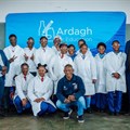 Supplied image: Talifhani Khubana (CFO, Protec), Munei Tshiovhe (GM Business Development, Protec) and Daniel Phukubje (Protec) with students at the official opening of the Science Resource Centre.
