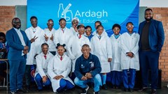 Supplied image: Talifhani Khubana (CFO, Protec), Munei Tshiovhe (GM Business Development, Protec) and Daniel Phukubje (Protec) with students at the official opening of the Science Resource Centre.