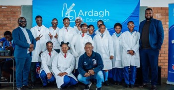 Supplied image: Talifhani Khubana (CFO, Protec), Munei Tshiovhe (GM Business Development, Protec) and Daniel Phukubje (Protec) with students at the official opening of the Science Resource Centre.