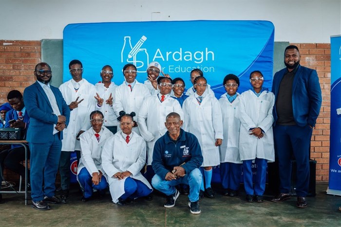 Supplied image: Talifhani Khubana (CFO, Protec), Munei Tshiovhe (GM Business Development, Protec) and Daniel Phukubje (Protec) with students at the official opening of the Science Resource Centre.