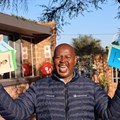 Kumba Iron Ore's Walter Khumo showcasing the newly published books. Image supplied.
