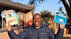 Kumba Iron Ore's Walter Khumo showcasing the newly published books. Image supplied.
