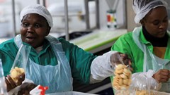 Source: Reuters/Esa Alexander. Workers interact while working on the production line at the factory of Khayelitsha Cookies, a Cape Town biscuit maker, in Cape Town, South Africa, 11 May, 2026.