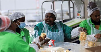 Source: Reuters/Esa Alexander. Workers interact while working on the production line at the factory of Khayelitsha Cookies, a Cape Town biscuit maker, in Cape Town, South Africa, 11 May, 2026.