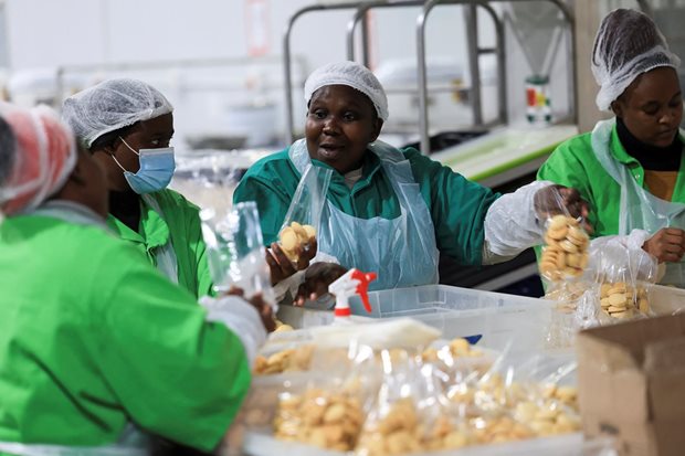 Source: Reuters/Esa Alexander. Workers interact while working on the production line at the factory of Khayelitsha Cookies, a Cape Town biscuit maker, in Cape Town, South Africa, 11 May, 2026.