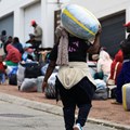 A Zimbabwean migrant carries luggage outside the Zimbabwe Consulate amid fears of anti-immigrant violence ahead of a June 30 deadline set by activists demanding undocumented migrants leave the country, in Cape Town, South Africa, June 22, 2026. REUTERS/Esa Alexander