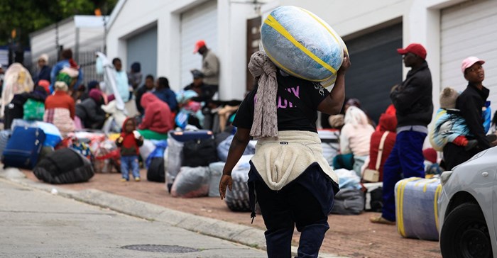 A Zimbabwean migrant carries luggage outside the Zimbabwe Consulate amid fears of anti-immigrant violence ahead of a June 30 deadline set by activists demanding undocumented migrants leave the country, in Cape Town, South Africa, June 22, 2026. REUTERS/Esa Alexander