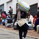 A Zimbabwean migrant carries luggage outside the Zimbabwe Consulate amid fears of anti-immigrant violence ahead of a June 30 deadline set by activists demanding undocumented migrants leave the country, in Cape Town, South Africa, June 22, 2026. REUTERS/Esa Alexander