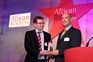 Tim Turner presenting the award for the business which has most contributed to MDGs to Anglo American.