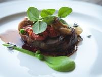 Main Course by Michael Broughton of Terroir Certified Karoo Lamb shoulder with its own juices, confit tomatoes, onions, peas & potato gratin