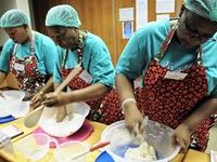 From back: Mamas Sipiwe, Phumelele and Nondumiso hard at work kneading the bread dough